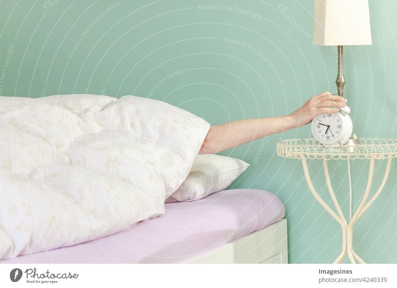 Good morning, get up! Turn off the alarm clock. Sleep concept wake up Arise Alarm clock Switch off Wake up more adult Watchfulness Flat (apartment) Bed