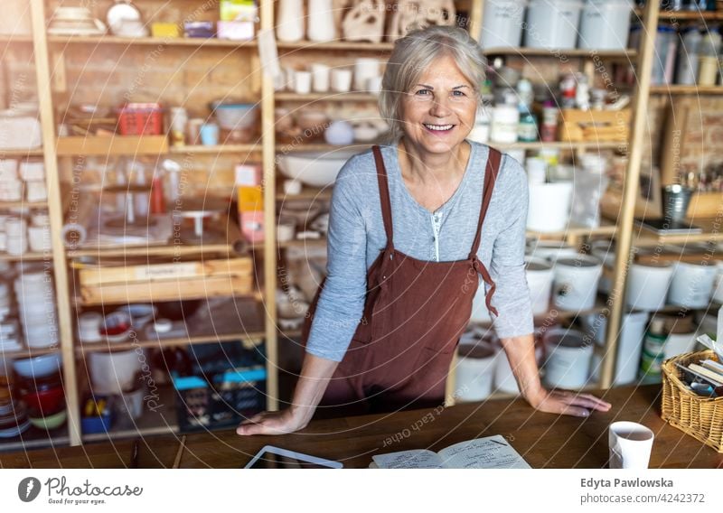 Portrait of an elderly potter in her art studio Pottery Artist work labour people Woman Senior citizen more adult Easygoing Attractive Happy Caucasian enjoying