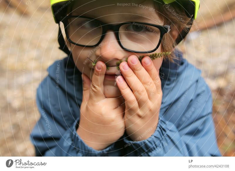 Child holding ferg leaf as a moustache Curiosity adult Surprise Style Masculine Gesture Body language Communicate Character Facial expression Mask Fine Stand