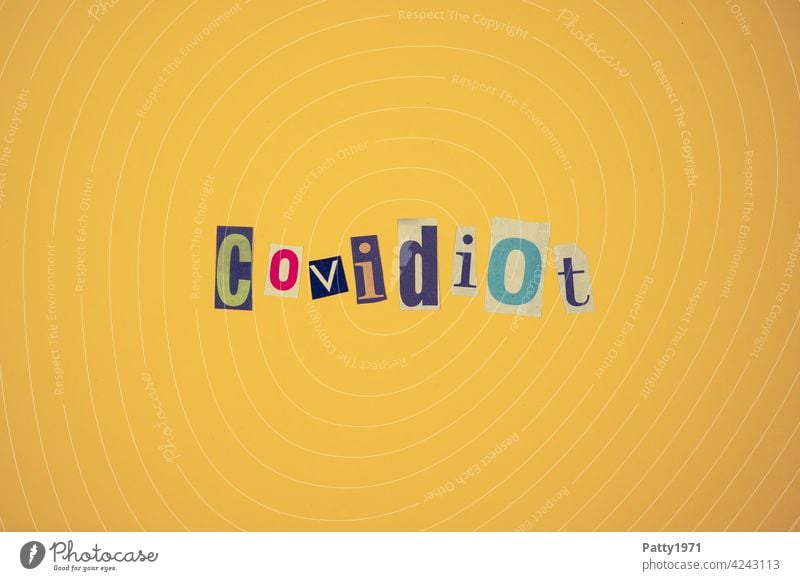 Cut out newspaper letters form the word Covidiot | corona thoughts pandemic Collage Corona denier opponent coronavirus Healthy Risk of infection