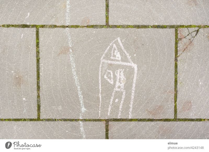 On the pavement slabs a child has painted a house and a path with white chalk / creativity House (Residential Structure) Children's drawing Stone slab