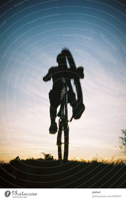 Bike into the night 2 Bicycle Human being Young man Youth (Young adults) 1 Sky Beautiful weather Cycling Jump Mountain bike Extreme sports Colour photo