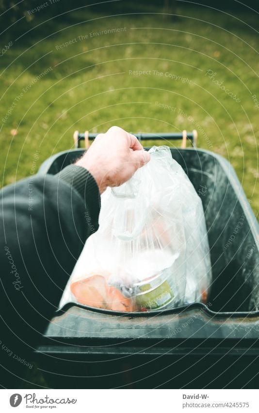 Man throws garbage in the trash can Trash dustbin Dispose of waste Throw away Waste management plastic waste yellow ton Arrangement Hand