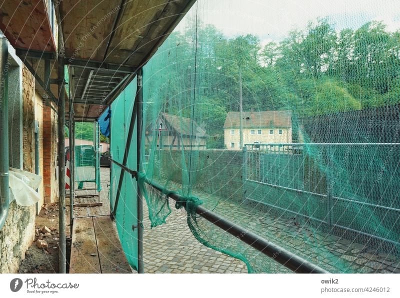 Behind the tarpaulin Construction site Gauze Protection Scaffold Translucent semitransparent Contrast Plastic Metal Sidewalk Street Structures and shapes