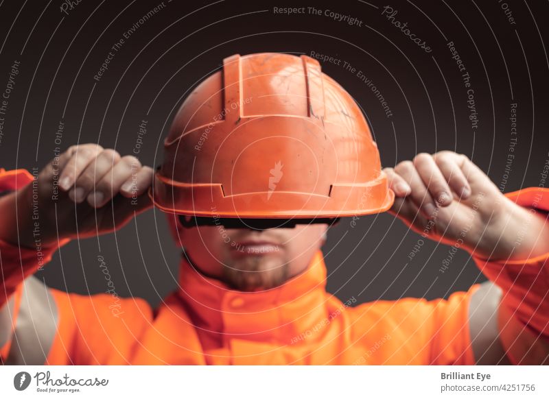 Railway worker puts on safety helmet Service Face Workplace people rail Engineer youthful Hat Working man job masculine Engineering Protective Helmet Profession