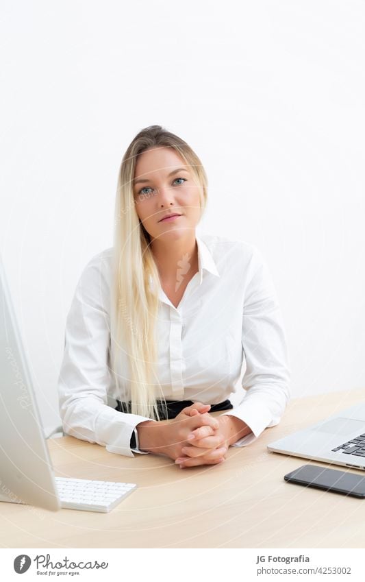 Young attractive businesswoman looking at camera in office. working corporate occupation girl career fashionable portrait pretty employee worker modern trendy