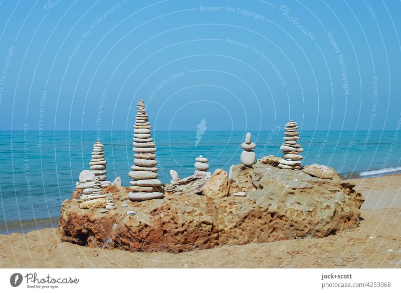 piled up stones at the summer beach Corfu Greece Cairn Balance Stack Spirituality Stone Man Pile of stones Beach equilibrium stone stack Nature