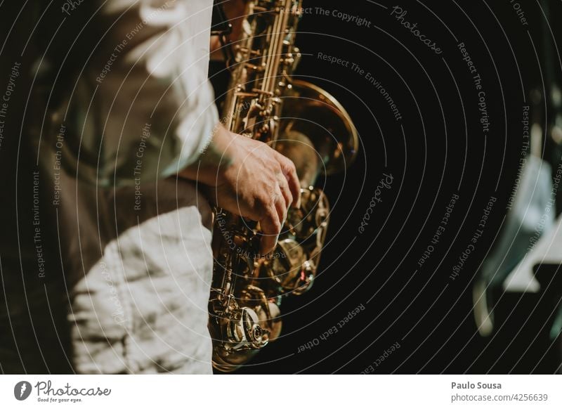close up hand holding saxophone Saxophone Saxophon player Music Musician Musical instrument Art Sound Human being Man Classical Jazz Concert Brass Elegant Style