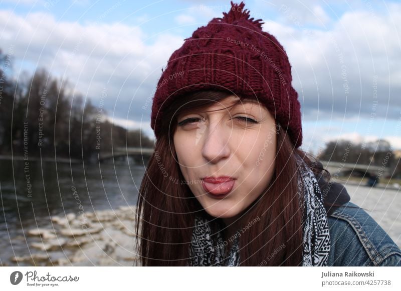 Young woman in cap sticks out her tongue Woman Cap Autumn Cold Human being Exterior shot Adults portrait 1 Winter Feminine Day Youth (Young adults)