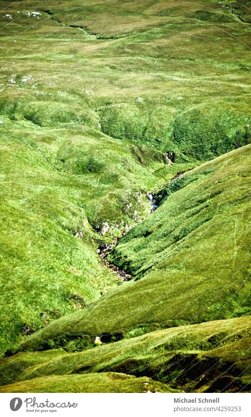 Stream flows through green meadows of Ireland Green Nature Juicy juicy green lush meadow Deserted tranquillity Peace silent Loneliness seek solitude Hill