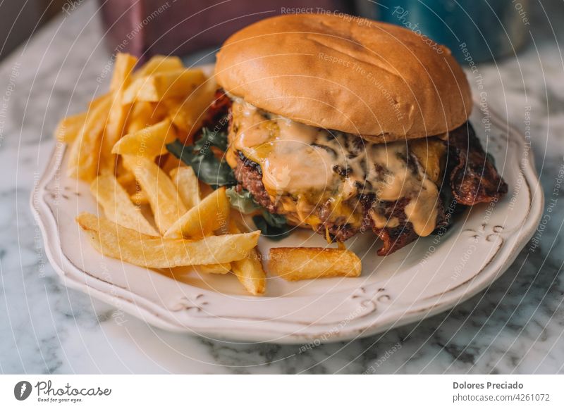 Beef cheese burger with fries ketchup isolated board table Cholesterol mayonnaise sauce arugula comfort food copy space double dinner delicious cuisine fresh