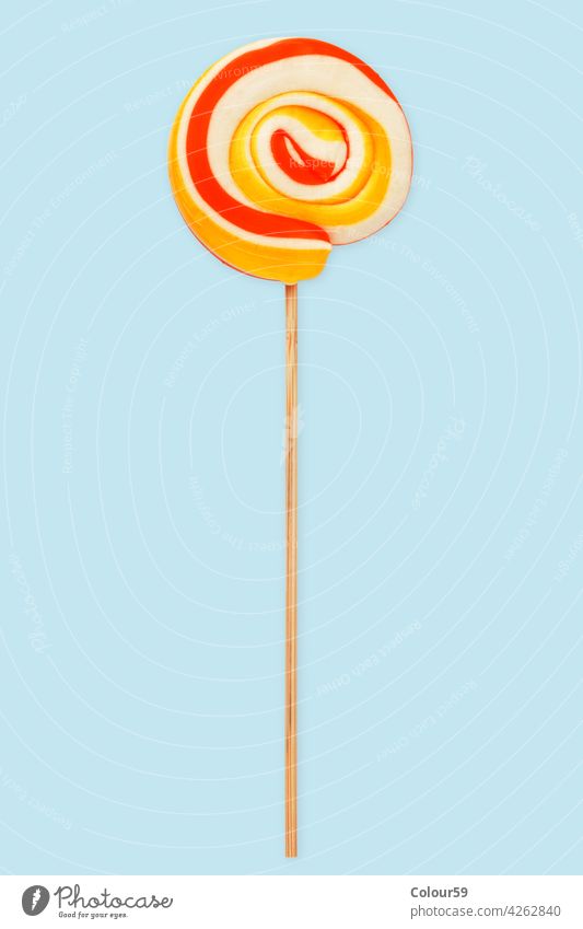 Lollipop over light Blue candy isolated spiral lollipop lolly swirl stick sweet sucker food colorful white dessert delicious background circle sugar striped