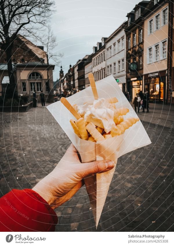 A portion of French fries with mayonnaise in the left hand on Hauptstraße, Heidelberg Mayonnaise Eating Fast food Food Fat Baden-Wuerttemberg Germany