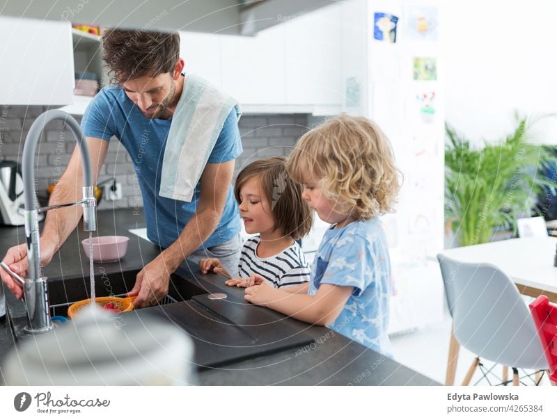 Children helping father in kitchen family people child son boy kid kids children happy lifestyle smiling happiness fun cheerful together offspring enjoying home