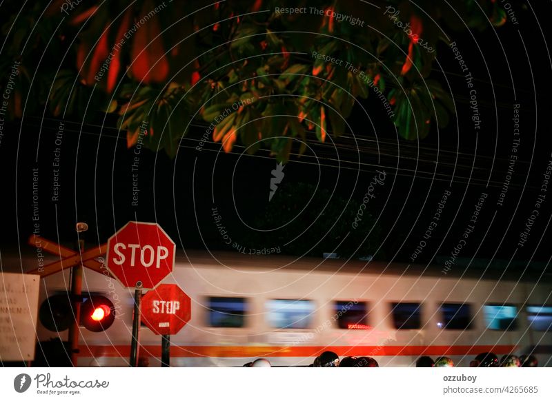 railroad crossing with passing train at night with Motion Blur Effect crossing sign light transportation speed motion traffic danger track railway red street