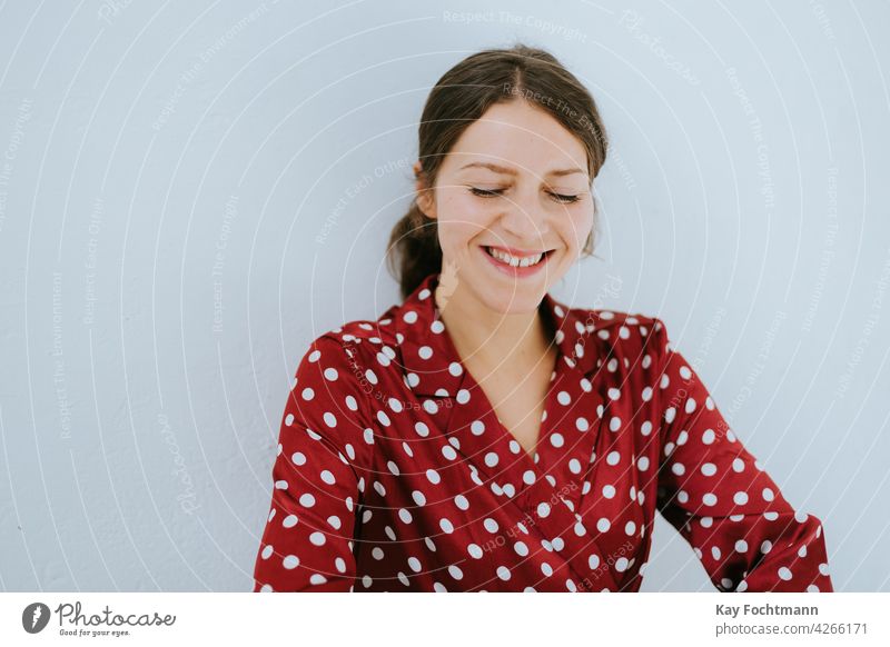 Portrait of pretty young brunette woman in mid 30s wearing casual