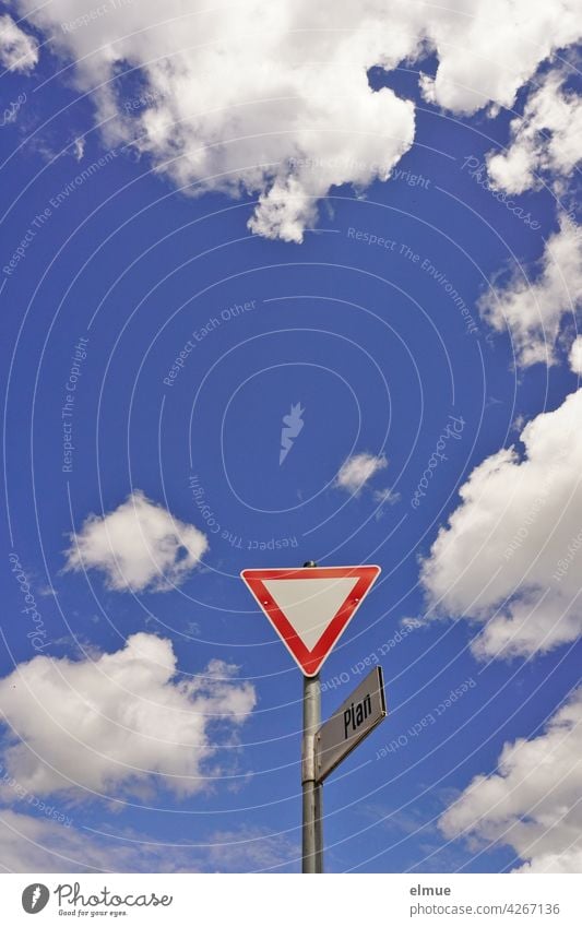 Traffic sign " Give way " with street sign "Plan " from frog perspective in front of blue sky with fair weather clouds / VZ 205 / Halt Road sign