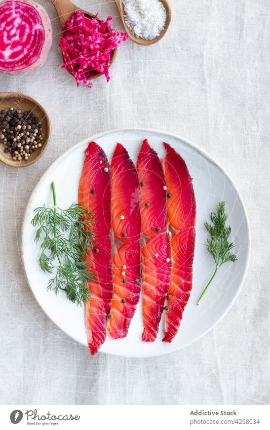 Smoked salmon slices on plate gravlax fish appetizer peppercorn dill beetroot smoked cured mix fresh herb natural protein organic delicious food piece dish