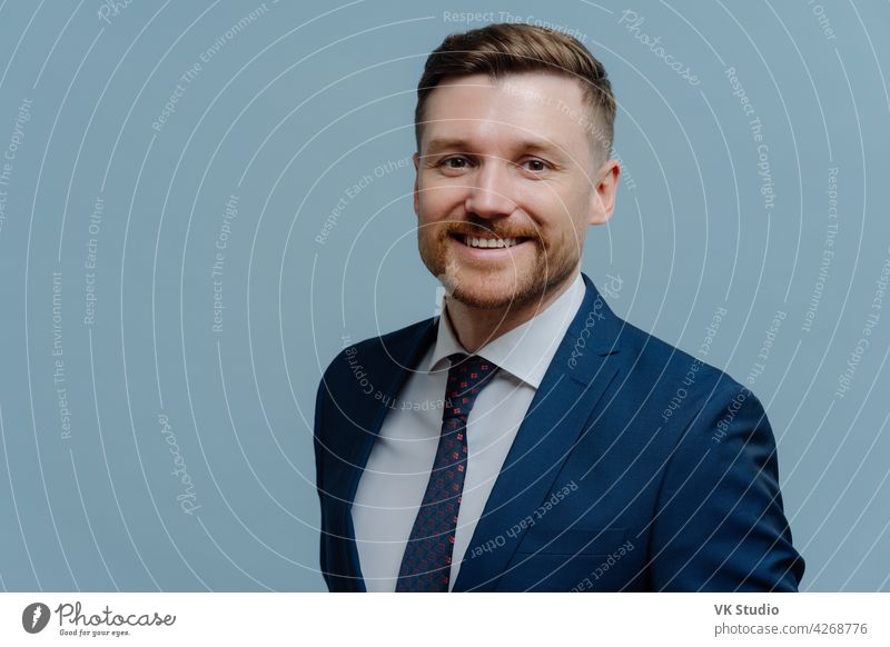 Portrait of happy handsome business man smiling at camera young successful businessman leader formal suit looking office confidence caucasian adult bearded male