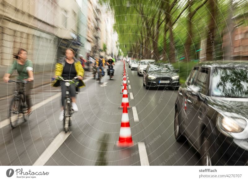 Bicyclists on a half of the road closed off with traffic cones Bicycle Cycling Cycle path, traffic, road, environment, city, urban bicycles persons turnaround