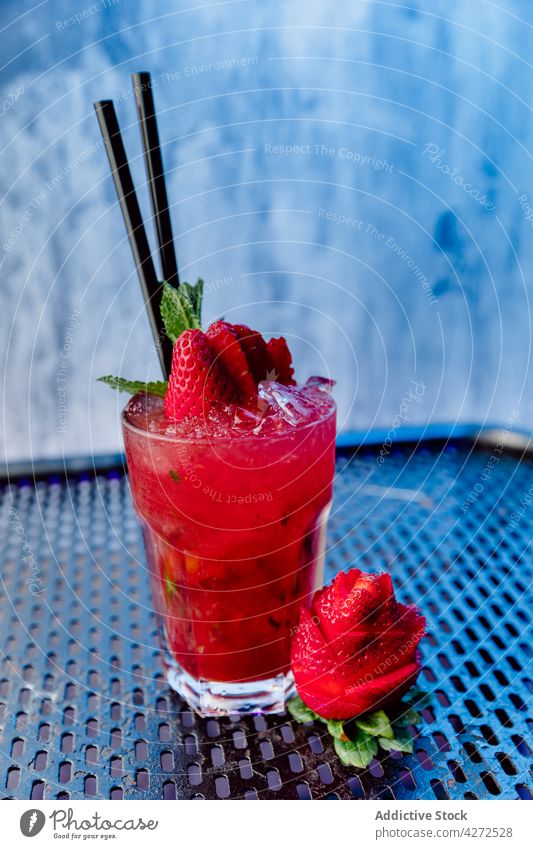 Glass of refreshing cocktail with strawberry mojito rum mint alcohol ice soda drink liquid glass beverage tasty leaf aperitif fruit cold cool refreshment bar