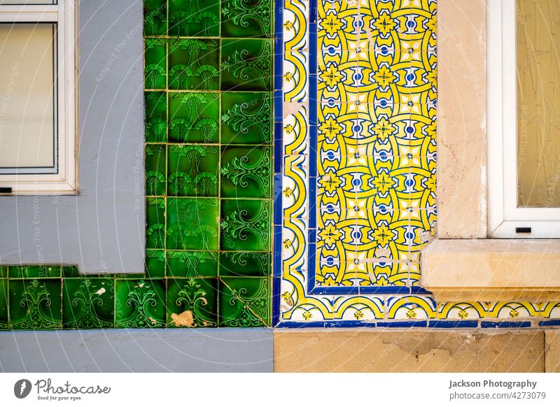 Close up of typical tiles on the facade of old houses in Olhao, Portugal portugal olhao azulejo detail close up architecture azulejos in a row afternoon algarve