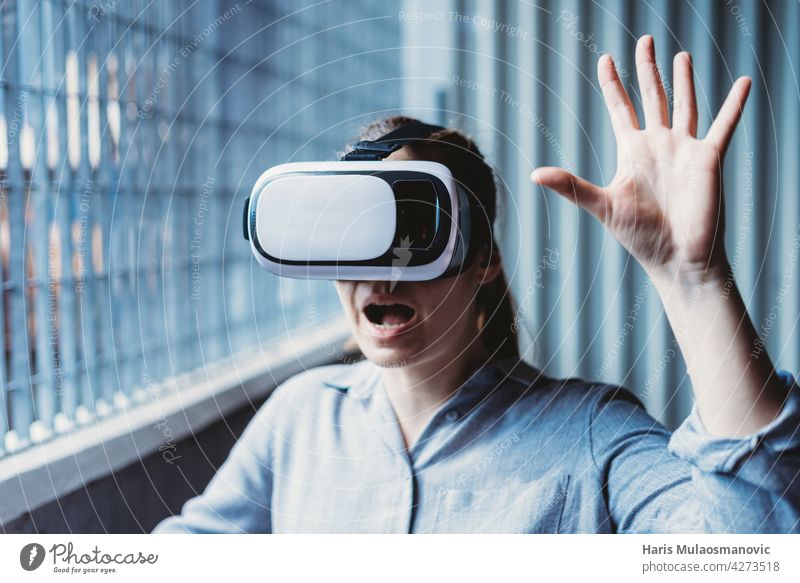 woman with vr goggles and facial expression enjoying virtual reality experience 3d adult background casual caucasian city creativity cyber device digital