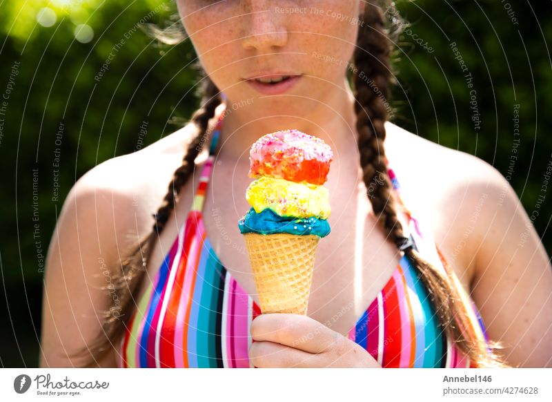 Young teenage girl eating icecream cone wearing pink sunglasses and braids on hot summer day child food person kid chocolate face human licking life lifestyle