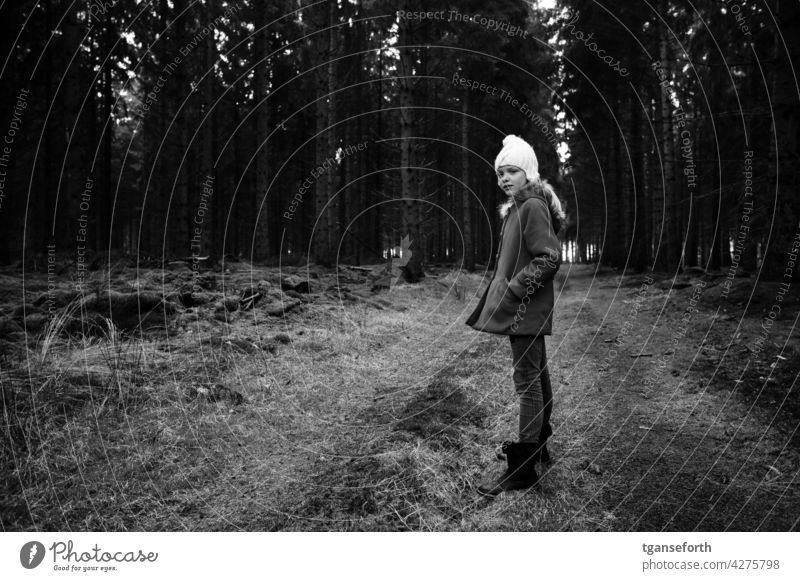 Winter walk in the forest Forest Child Cap Cold To go for a walk Walk in the nature Black & white photo forest path Nature Exterior shot trees Coat Hiking Tree
