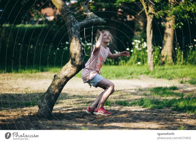 Child playing with a rope on an apple tree in the garden Playing Garden Tree Apple tree Colour photo Exterior shot Climbing To swing Joy Summer Happiness Nature