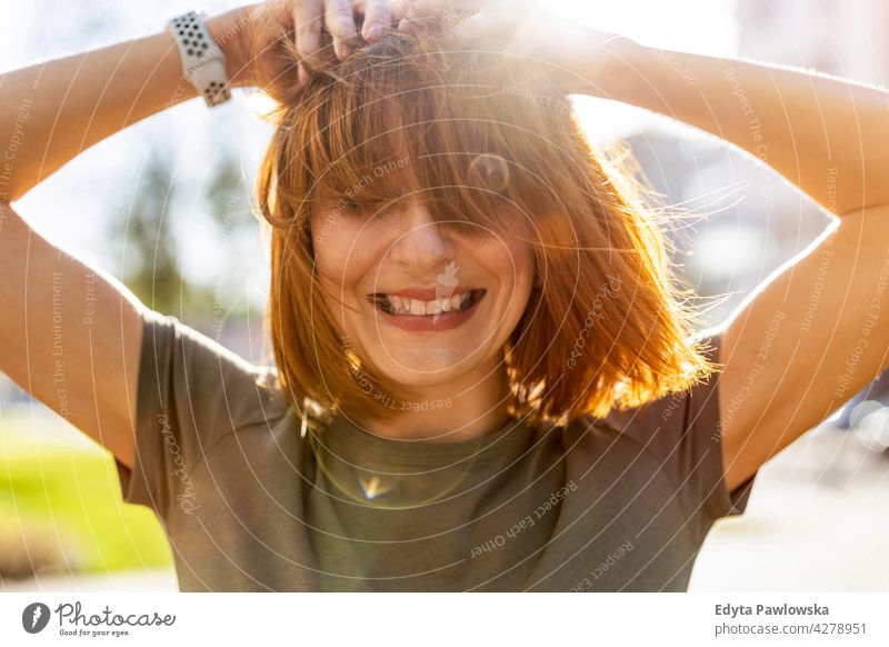 Portrait of a beautiful happy woman outdoors park nature green spring red hair redhead sunny outside pretty girl person adult confidence summer beauty female