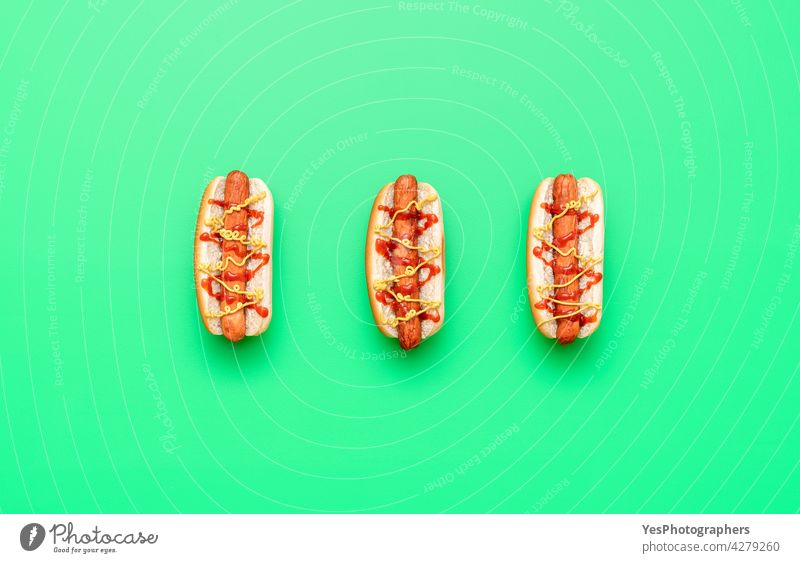 Hot dogs top view minimalist on a green table above american background bread bun calories color copy space cuisine cut out delicious eat fast fast-food