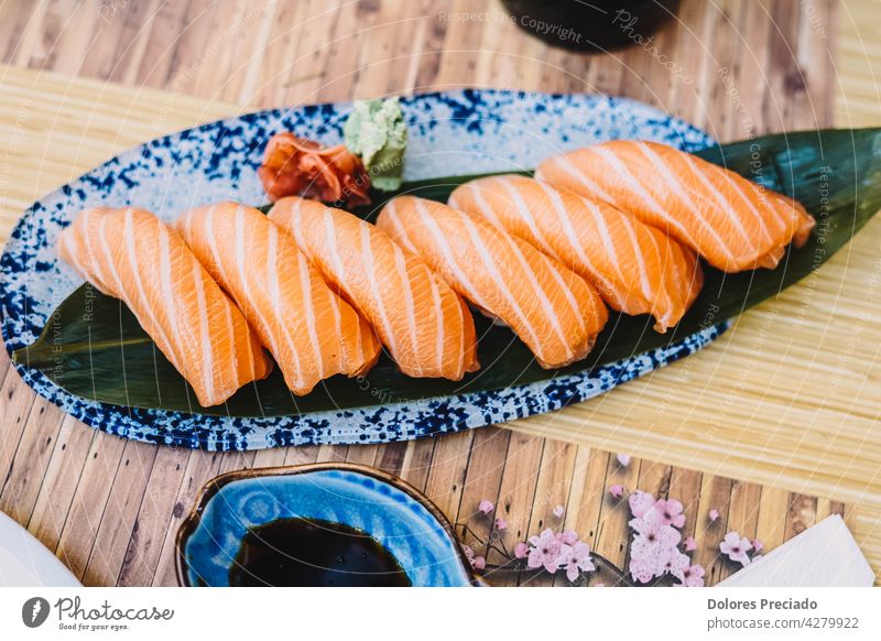 Plate of salmon niguiri with soy sauce in a sushi restaurant appetizer asia asian assorted background closeup closeup japanese food cuisine culture delicacy