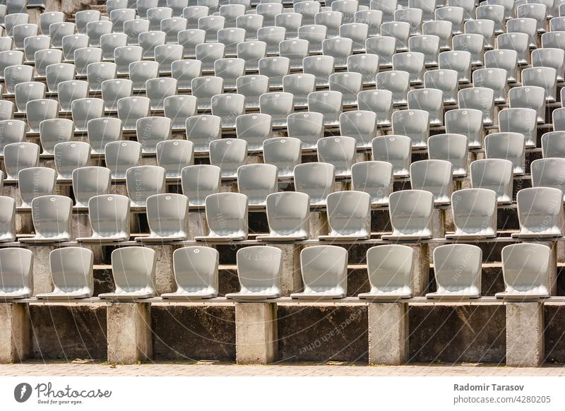 rows of plastic seats in the stadium event chair empty concert seating nobody background sport pattern stand bench audience section horizontal theater color