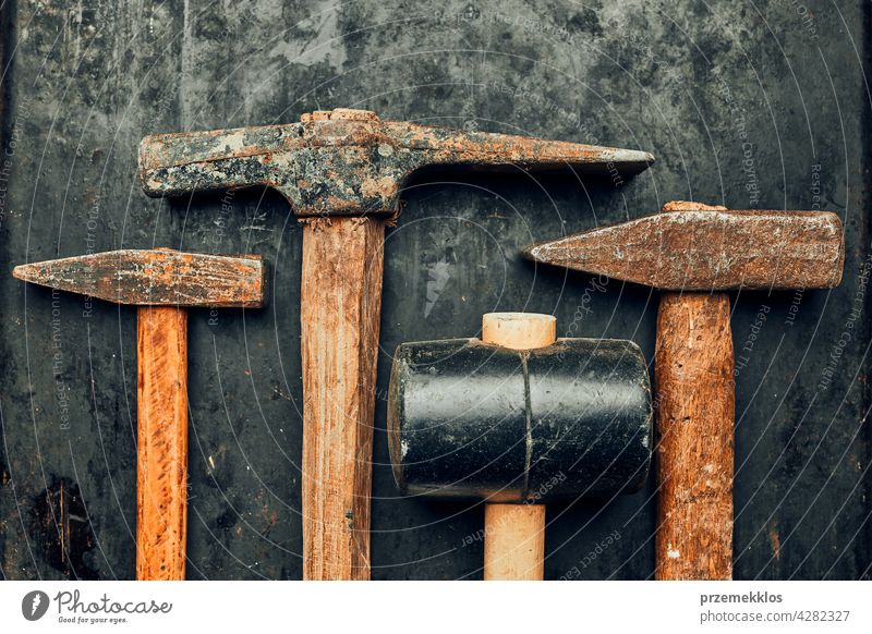 Old hammers on steel surface. Rusty tools for maintenance. Hardware tools  to fix. Technical background with copy space - a Royalty Free Stock Photo  from Photocase