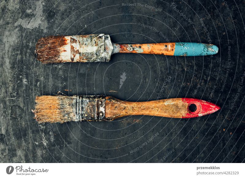 Paintbrushes on metal surface. Old brush set for house maintenance. Technical background hardware tool steel old used heavy useful workshop improvement supply