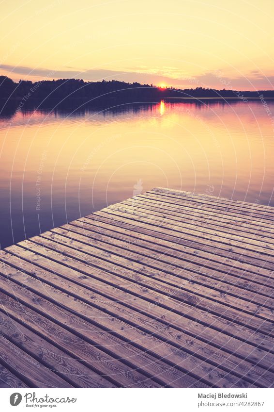 Wooden pier at golden sunset, selective focus, color toning applied, Strzelce Krajenskie, Poland. lake outdoors nature reflection calm peaceful serene scenic