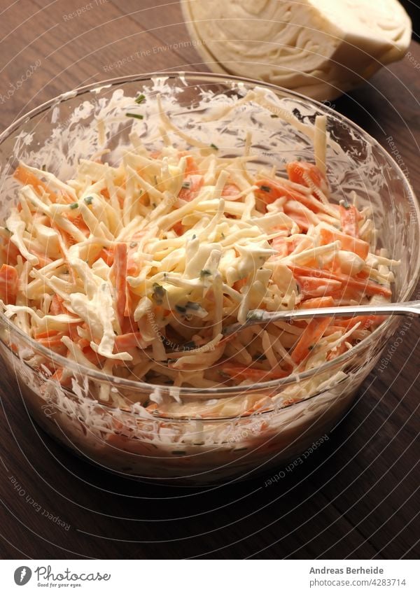 Traditional white cabbage salad with carrots ,chives, natural yogurt and vegan mayonnaise. Everything in organic quality appetizer bowl chopped closeup coleslaw