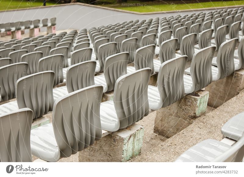 rows of plastic seats in the stadium event chair empty concert seating nobody background sport pattern stand bench audience section horizontal theater color