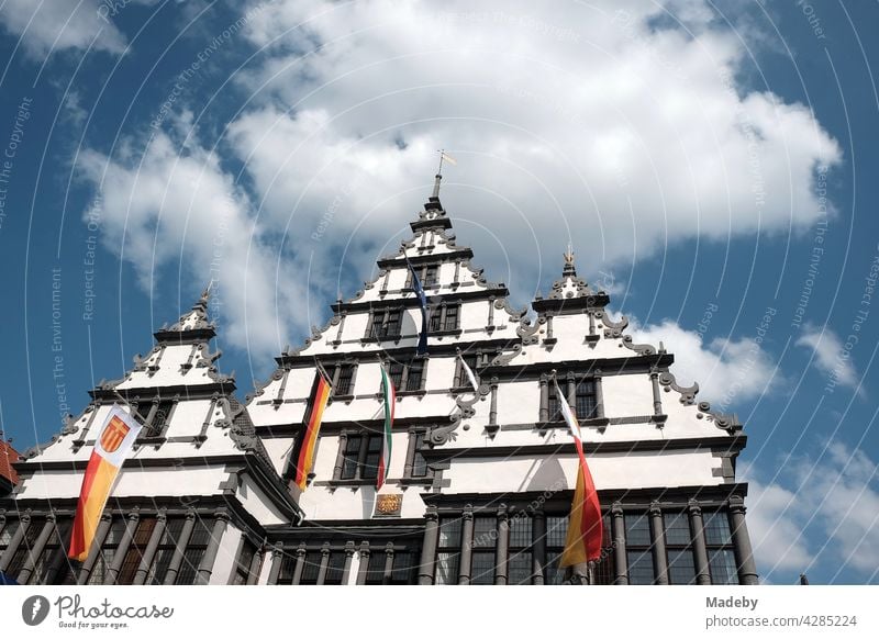 The historic town hall in the style of the Weser renaissance with flag decoration in sunshine in the bishop's town of Paderborn in East Westphalia-Lippe