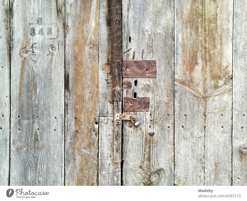 Old wooden door with rusty fittings and traces of past times in the old town of Tarakli in the province of Sakarya in Turkey Wood Wooden door boards shack Flake