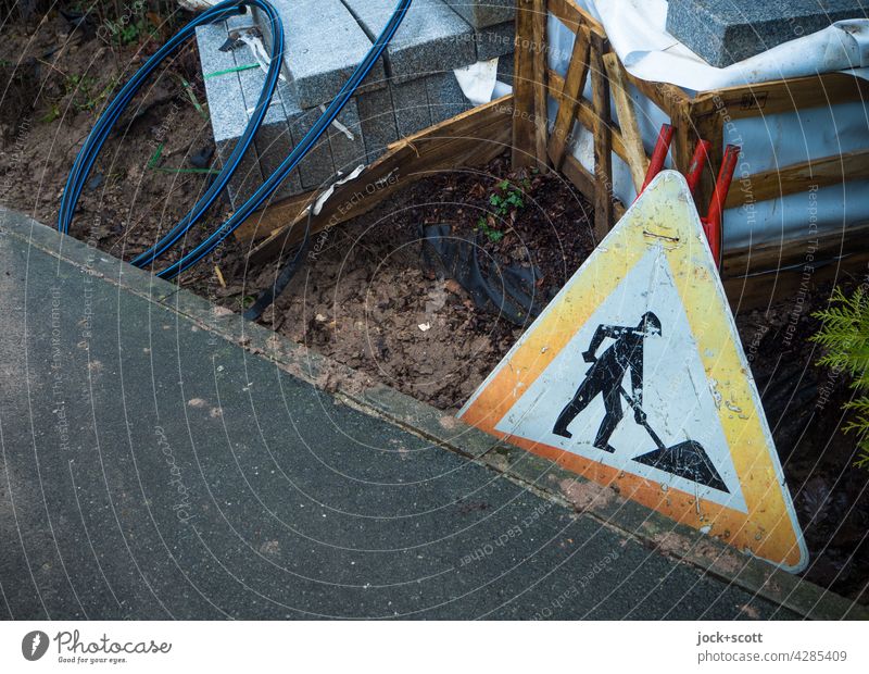 Baustelle - a road sign for Germany at the roadside Road sign StVO Triangle Signs and labeling Warning sign Safety Pictogram Caution Construction site Asphalt
