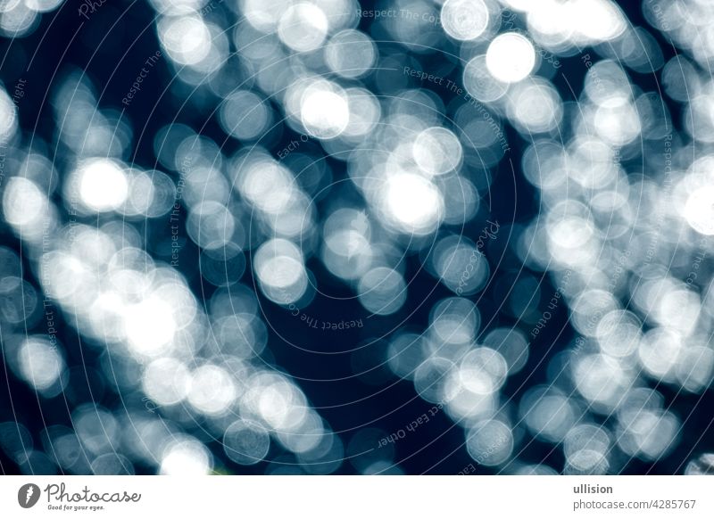Dark Blue bokeh background. De-focused Abstract Light Circles, sea christmas background with blur bokeh light effect. sea background space glowing falling snow