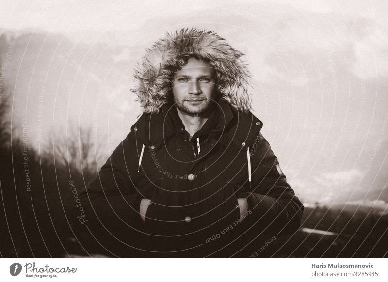 portrait of a man in black and white in jacket winter time Man Mountain Jacket Black & white photo outdoors