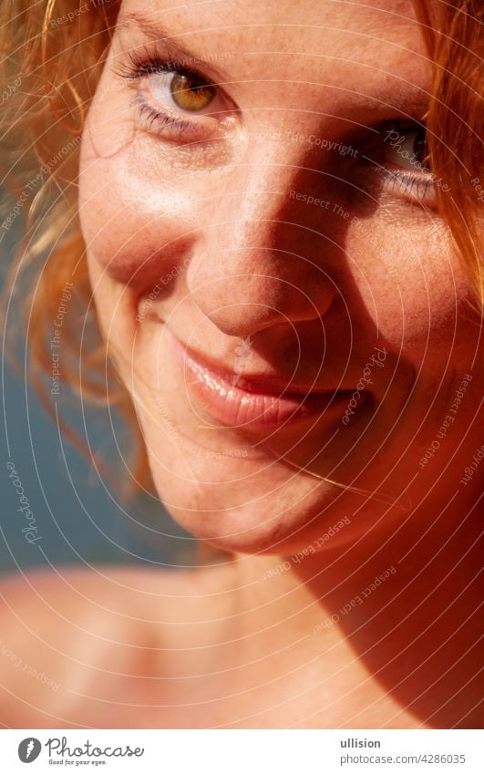 beautiful portrait of a happy redheaded woman in closeup joy carefree lifestyle sunny joyful holiday freedom happiness vacation outdoor fun casual cheerful
