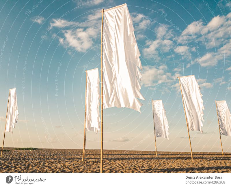 White flags on an early morning sunrise at the beach in Bali Denpasar Seminyak white white flag sonnenaufgang ocean bali seminyak ozean cloud nature seaside