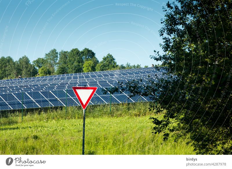 Right of way - sign in front of a solar park surrounded by trees and meadow. Symbolic image, promote regenerative energies as a priority. Solar funding