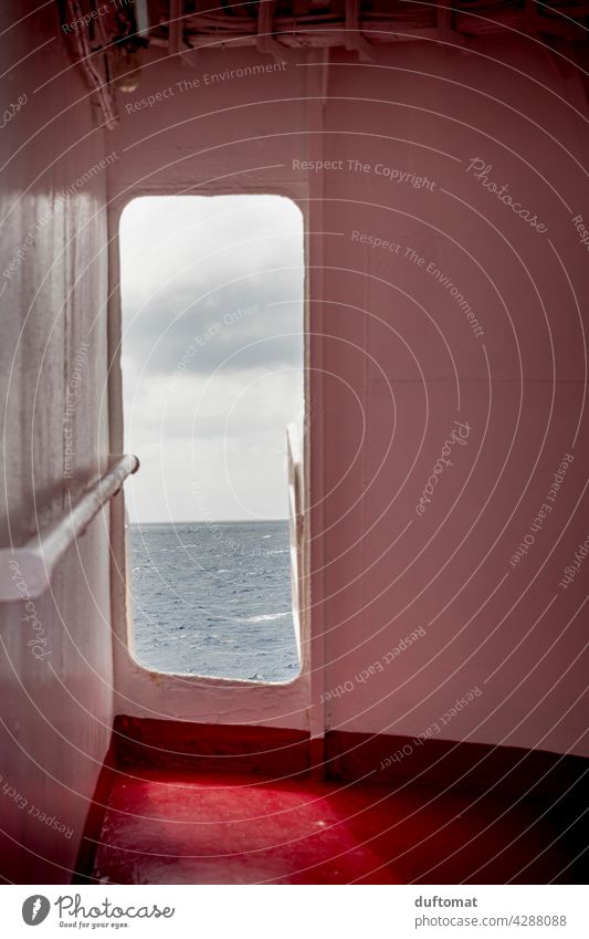 View of the sea through door in the ship Ocean Mediterranean sea Sky Water Summer Horizon Blue Ferry Vacation & Travel coast Wanderlust Perspective Peephole