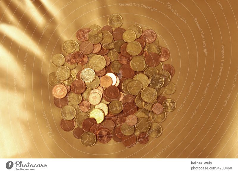 Many euro cent coins on a golden background - financial cushion from a pile of small change Money Cents Coin Euro Paying Financial Industry Economy finance Save