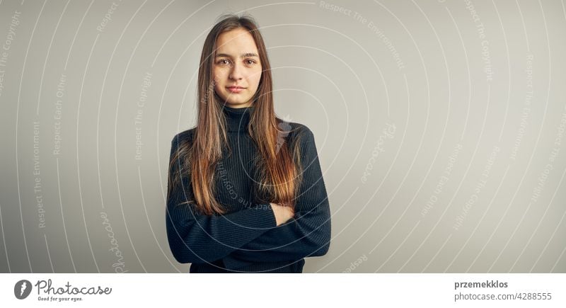 Portrait of young woman. Classic portrait in positive mood, beautiful model posing in studio over plain background headshot person female teenager pretty lady